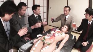 Female Domination Group of business men eat sushi off her beautiful body Male